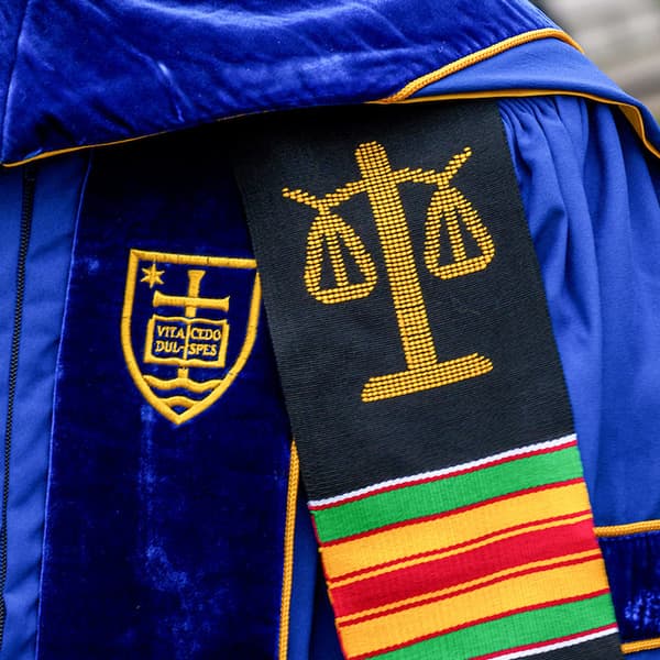 Law School stoll shown on graduation gowns.