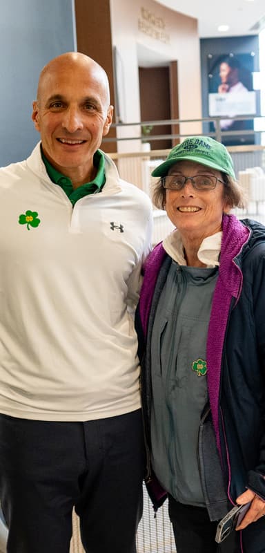 Pete Bevacqua poses for a photo with a woman during an event for the Rockne Athletics Fund